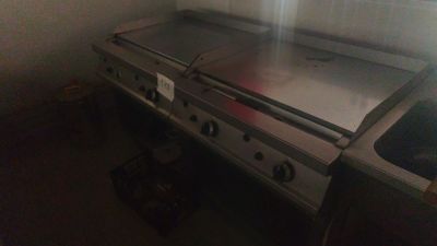 a silver stove top in the corner of a kitchen