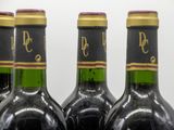 three bottles of wine are lined up in a row
