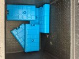a blue toy that is inside of a metal box