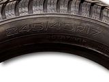 a close up of a tire on a white surface with a white background