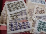 a lot of stamps sitting on a red table