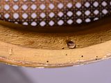 a close up view of a gold plate with holes in it