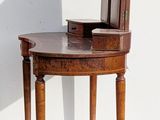 a small wooden table with a book on top of it