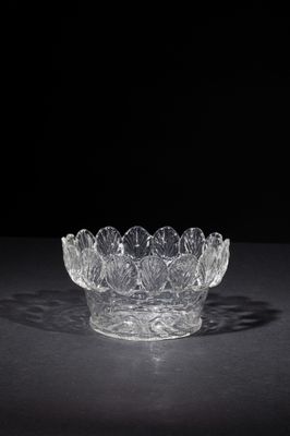 crystal bowl on a black surface with a black background