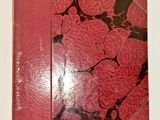 a red book with black and white designs on it