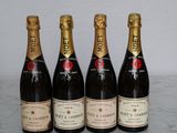 three bottles of champagne are lined up on a marble table