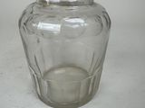 a clear glass vase with a candle inside of it