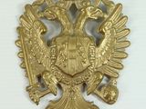an image of a gold eagle with a crown on it ' s head