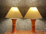 two lamps that are on a table in a room