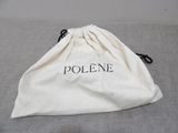the bag is sitting on the bed with the name polone printed on it