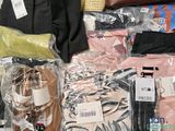 a lot of clothes and other items that are on the floor