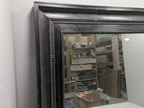 a mirror that is on a shelf in a room