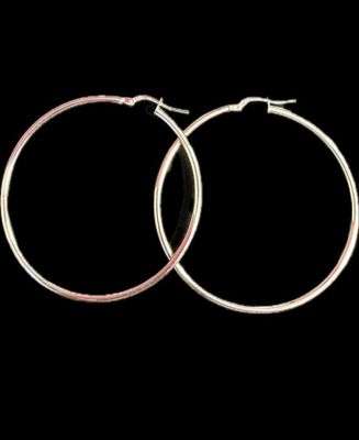 une paire de boucles d'oreilles créoles en argent sur fond noir