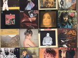 many different album covers on the wall of this room