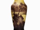 a vase that has a picture of a house on it