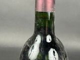 a wine bottle with a picture of a man and a woman inside of it