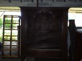 a wooden bed in the middle of a room with a ladder