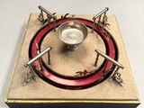 a small metal object with a red ring around it