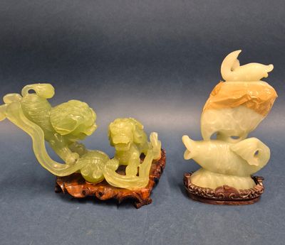 pair of carved jade figurines of a boy and a girl on a boat