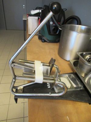 a metal sink and a metal pot on a counter