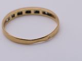 a close up of a gold ring with black diamonds on it