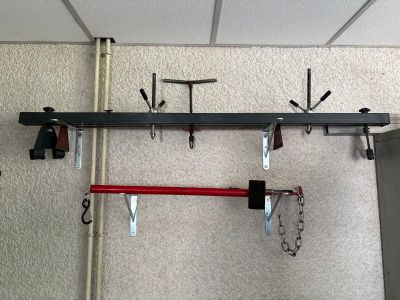 a rack with tools hanging from it on the wall