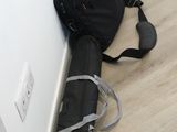 a black bag and a cane sitting on the floor next to a wall