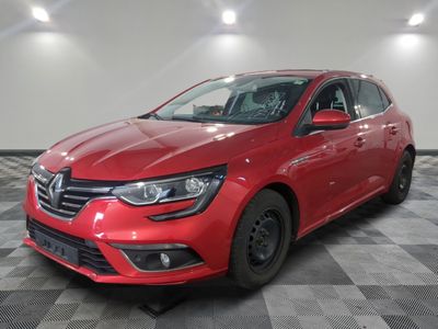 a red car is parked on a checkered floor in a garage
