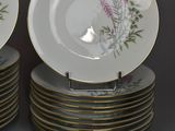 many plates and saucers stacked on top of each other