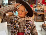 a figurine of a man holding a basket of vegetables