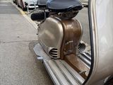 a scooter that is parked on the side of the street