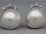 a pair of pearl and diamond earrings