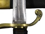 a close up of a sword with a gold handle
