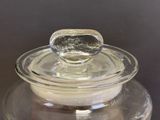 a glass jar with a lid that has a spoon in it