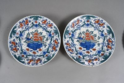 two blue and white plates with floral designs on them sitting on a table