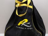 a black bag with a yellow handle on a white table