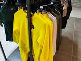 a rack of shirts on display in a clothing store