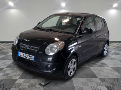 a picture of a small black car parked in a garage