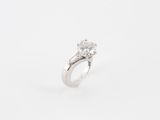 a close up of a diamond ring on a white background