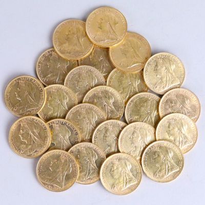a pile of gold coins sitting on a white surface