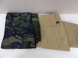 two pairs of pants sitting on top of a white table