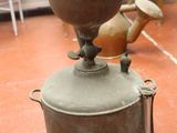 pots and pans sitting on top of a red floor in a room