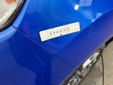 a sticker on the front of a blue car
