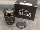 the lens is sitting next to the box of the camera