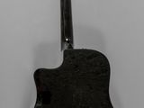 black and white photograph of an acoustic guitar on a white background