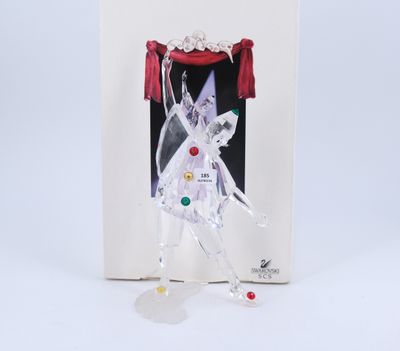 an ornament in a box with a picture of a woman in a white dress