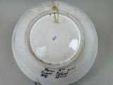 a white plate with writing on it sitting on a table