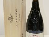 a bottle of wine sitting next to a wooden box