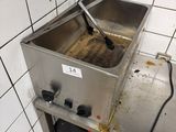 a dirty sink in a public restroom with a sign on it