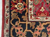 an image of a red and black area rug with a floral design